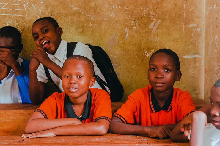 group children sit front wall with boy wearing shirt that says word it 751167 294